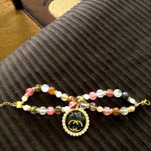 Gold and neutral colors tray charm bracelet.